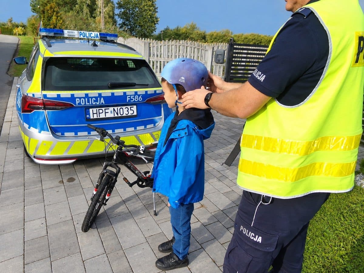 Policjant podczas kontroli rowerzysty w ramach kampanii Kask na głowie